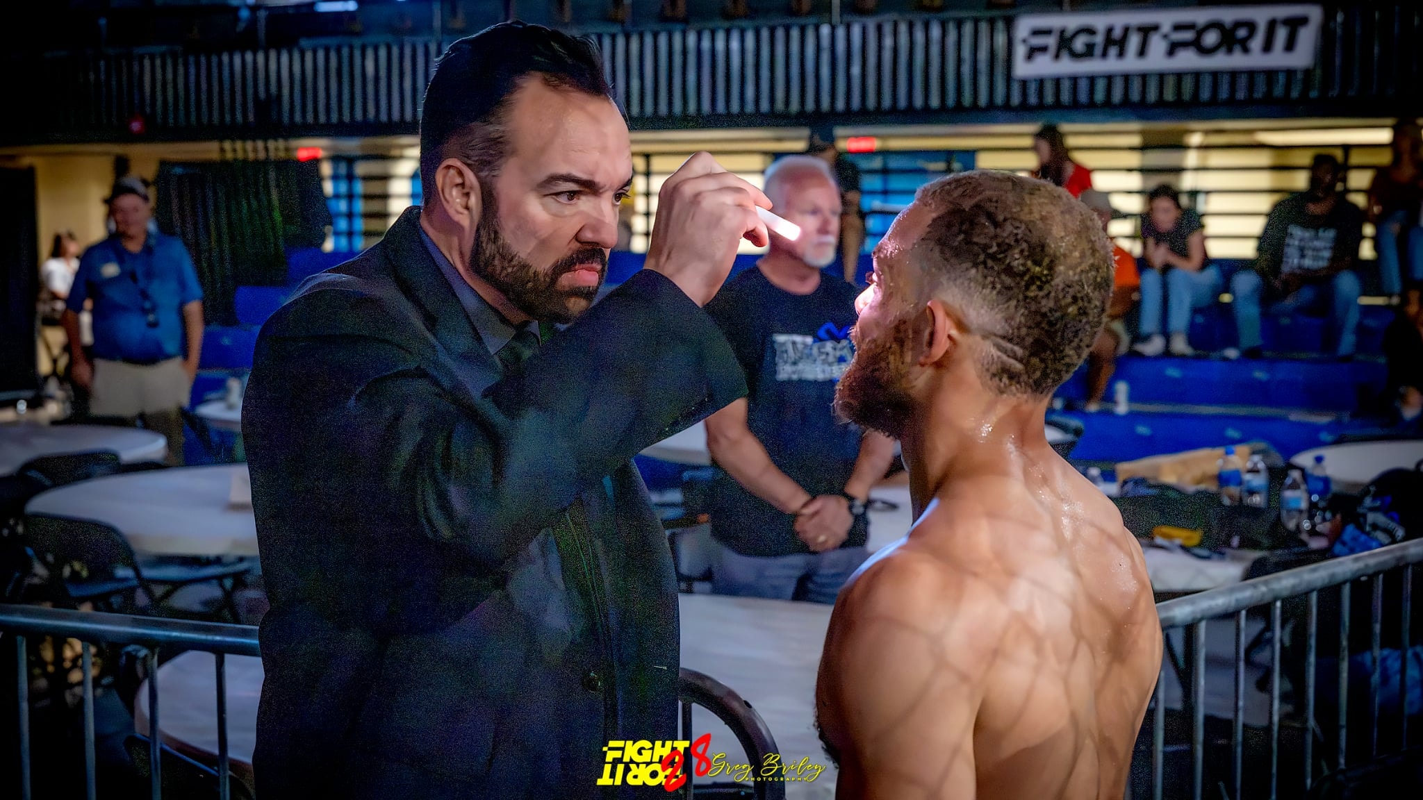 Dr. Robert Clinton performing a fight doctor medical examination on a fighter